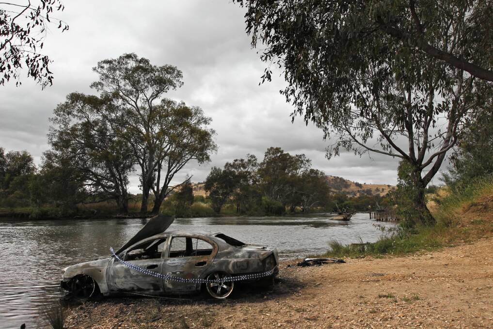 A Ford Falcon is the latest car to be stolen, taken on a joyride and torched on the Border. It was taken from a William Street address and dumped and torched at Wodonga Creek. Pictures: BEN EYLES