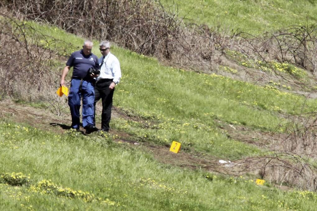 Police search the scene of the shooting death of Wodonga’s Ryan De Angelis, inset, at Merriang in 2010.