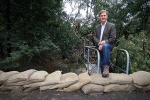 Deputy Premier Peter Ryan surveys sandbags at the Wangaratta levee during last year's September floods.