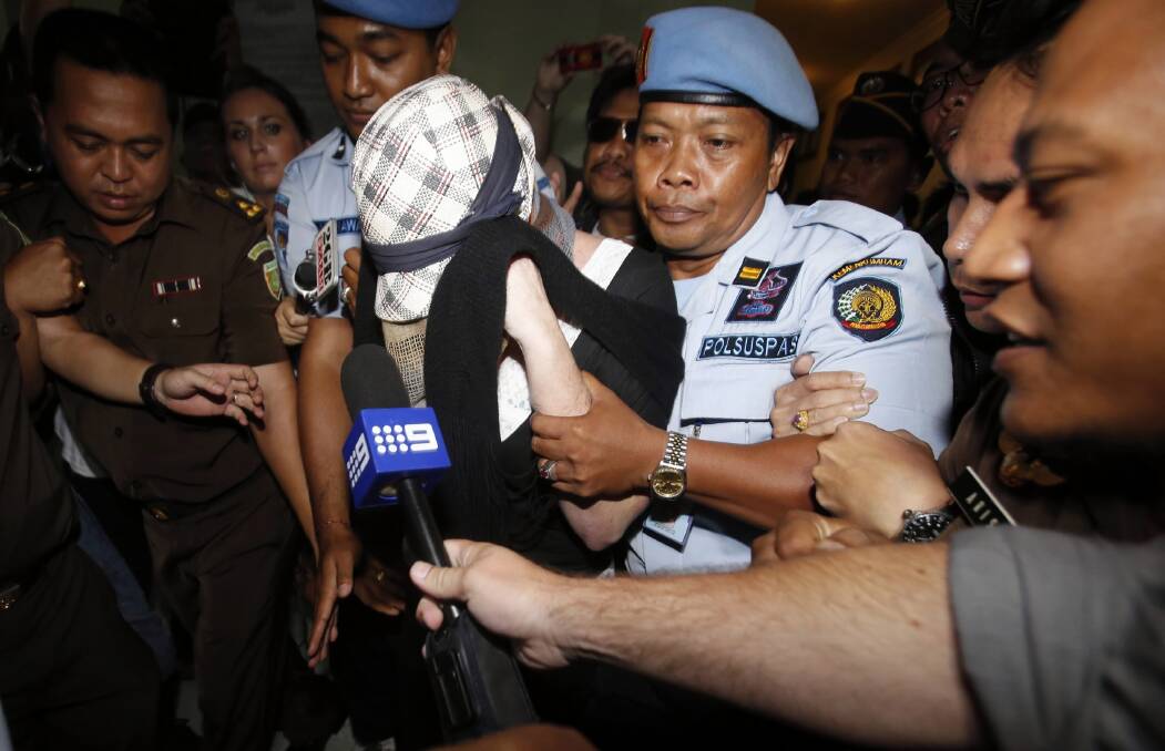 Schapelle Corby is escorted by police following her release from Kerobokan prison. Picture: REUTERS