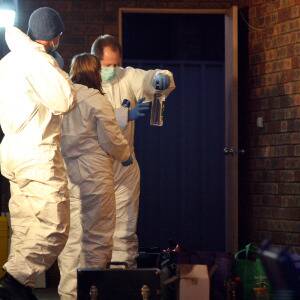 Forensic chemists go over what was found during the raid. Picture: BEN EYLES