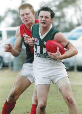 Rennie’s Damien Powell protects the ball from Jerilderie’s Chris Marshall. Picture: JOHN RUSSELL