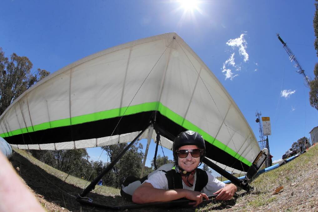 Pilot Rory Duncan conducts some pre-flight checks at Corryong. He didn’t fly yesterday as the wind picked up too soon. Pictures: PETER MERKESTEYN