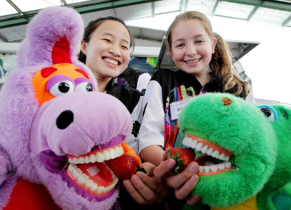 Charles Sturt oral health student Thoa Tran yesterday preached the value of healthy eating in the fight against tooth decay to Wodonga West student Britney Coleman. Picture: DAVID THORPE