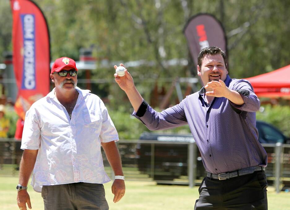Albury councillor Ross Jackson shows off his throwing technique in front of Australian cricket legend Merv Hughes yesterday.