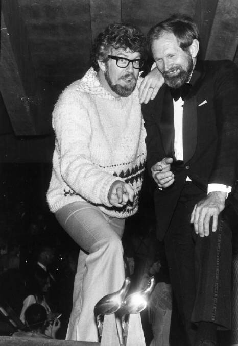 Two bushwackers, Rolf Harris and Harry Butler, get together to admire Harry's awards after the show in 1977.