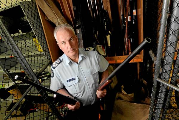 Wodonga’s Senior Sergeant Garry Corcoran with some of the firearms handed in. Picture: David Thorpe