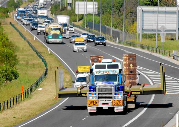 The log deck approaches the Borella Road bridge on its way to Norske Skog. Picture: DAVID THORPE
