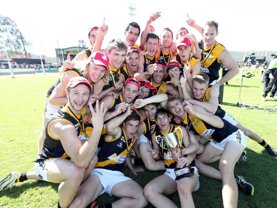 The victorious Albury Tigers reserves side celebrates its win yesterday. Pictures: PETER MERKESTEYN