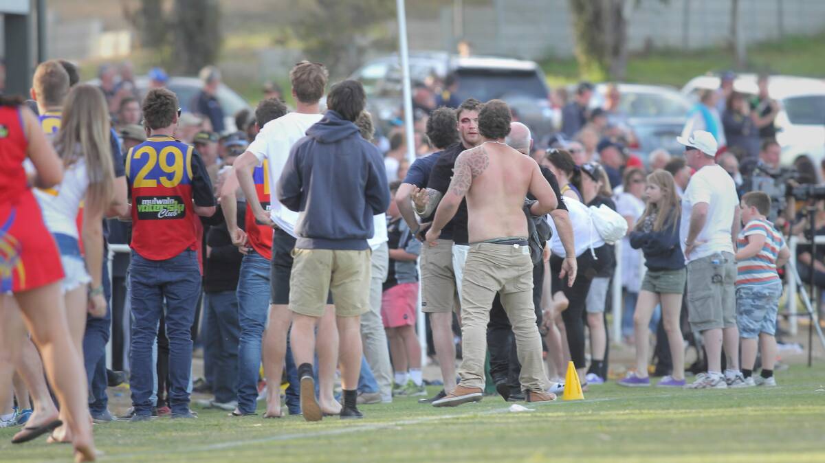 A fight at the Murray league’s grand final on Saturday drew a large crowd beside the oval. Pictures: BEN EYLES