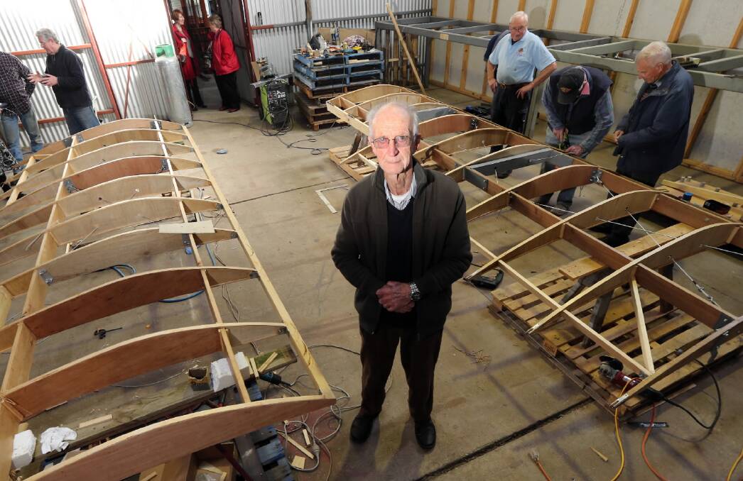 Geoff Robbins stands near the wings as they are being constructed. The plane is a replica of the one flown by his great uncle, Azor Robbins. It will hang in the Albury Library Museum. Pictures: PETER MERKESTEYN