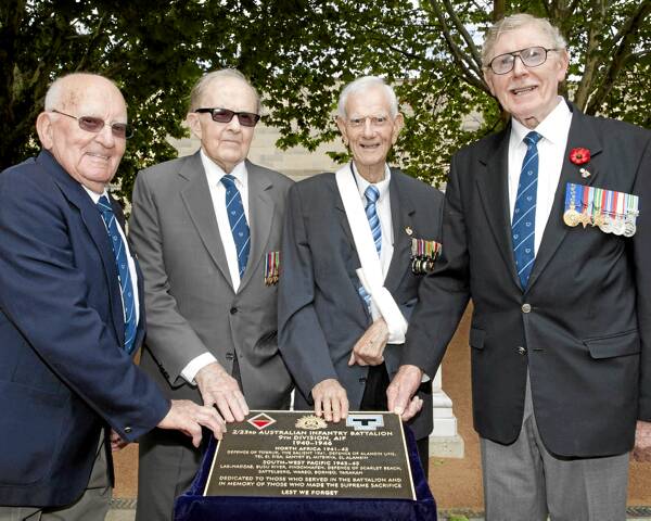 Ken Kearney, Roy Bryant, Jim Henderson and Don Tibbits with the plaque after the unveiling in Canberra yesterday afternoon. Picture: KERRY ALCHIN/AUSTRALIAN WAR MEMORIAL