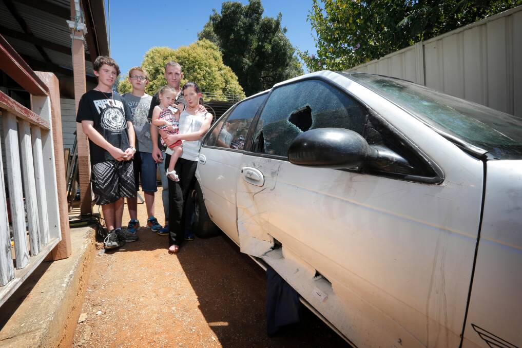 Jesse and Jye Cooke, Hayleigh-Jade Peterson, 2, Brett Collins and Stacey Peterson inspect the damaged car. Picture: Tara Goonan