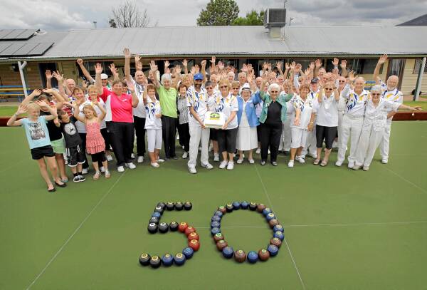Kiewa Valley Bowls Club president Rikki Schliebs and secretary Heather Schliebs, centre, surrounded by members and guests. Picture: TARA GOONAN