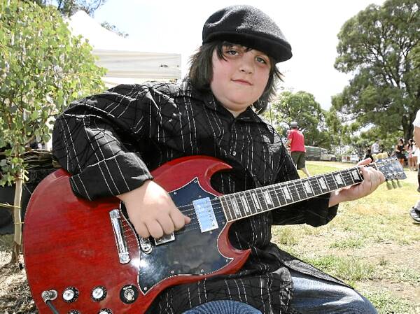 Keeping the crowd entertained was busker Jack Mostyn 10, of Myrtleford and his electric guitar.