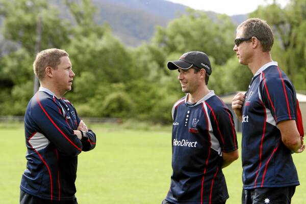 Troy Thomson (left) speaks with Rebels physios Paul Percy and Dave Rundle in the North East. Picture: PETER MERKESTEYN