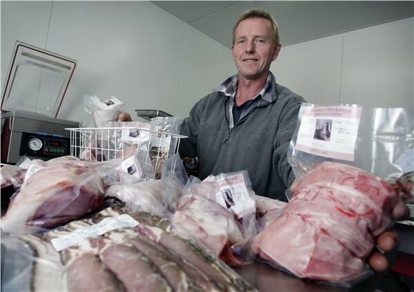 Robin Behrendt and some of his King Valley Free Range Pork ready for sale. Robin and his wife sell their pork at local markets and in Melbourne. Pictures: MATTHEW SMITHWICK