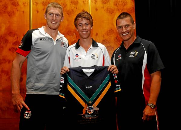 Nick Coughlan receives his jumper from Ben McEvoy, left, and Glen Jakovich, right.