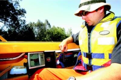 Albury SES member Scott Richter monitors sonar equipment. It has been used in the search for the body. Pictures: NIC GIBSON
