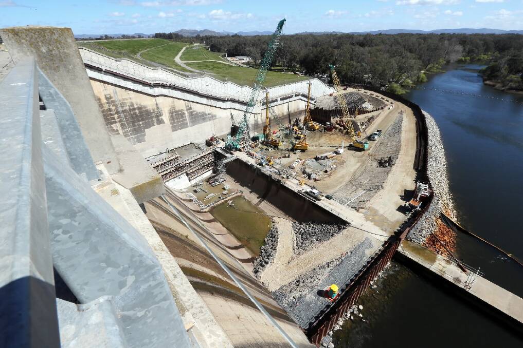 From a distance, the newness is obvious. Close up, it is a mighty 50,000 tonne concrete buttress 110 metres long and 33 metres high on the Hume Dam’s southern bank.  The coffer dam that allowed the construction. Pictures: KYLIE ESLER and JOHN RUSSELL