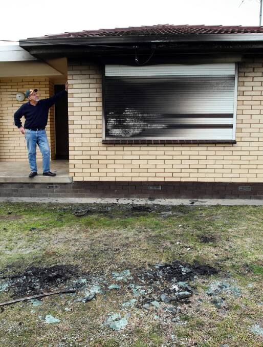 Mr Ford shows the damage to his Lavington home after his car was torched. Pictures: MATTHEW SMITHWICK 