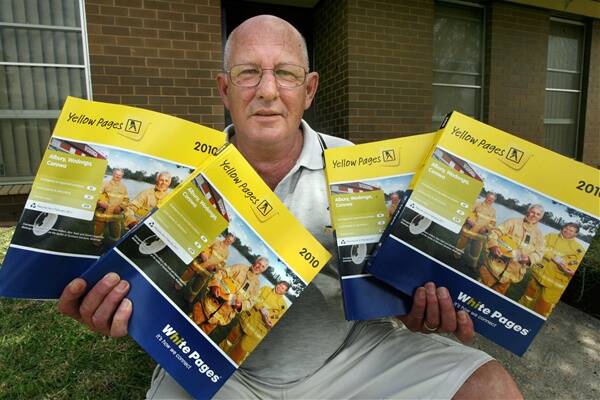 Wodonga's Terry Clear with the four phone directories he has received.