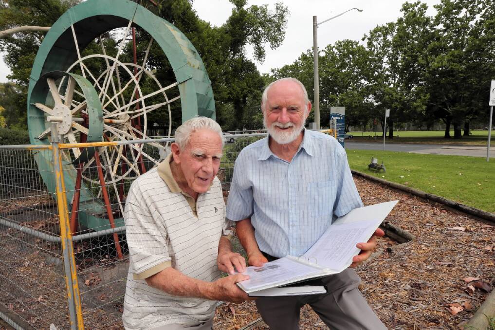 Frank Lange and Peter Carver have a few ideas on restoring the Australia Park water wheel. Picture: PETER MERKESTEYN