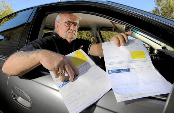 Ken Caddaye, with his two registration forms, after being fined for driving an unregistered vehicle. Picture: TARA GOONAN