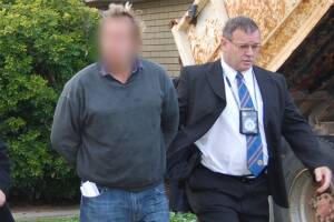Police arresting Adam Gilbert Jolly at his North Albury in August.