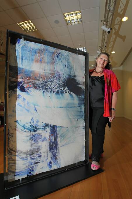 Marijana van Zanten with her painting The Weir at Art Space Wodonga. Picture: DAVID THORPE