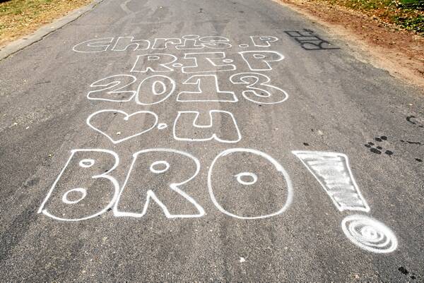 Tributes to Chris Peachey are painted on the road near the scene of the crash.