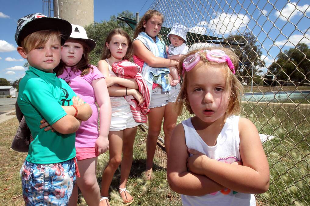 It’s just not good enough ... Lara Hayes, 3, front, together with Jack Costigan 7, Zoe Stevens 9, Ruby Wallden 9, Olivia Hayes 12, and Hunter Hayes, 6 months, are not impressed the pool is not open for them to have a swim. Picture: MARK JESSER