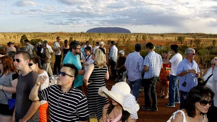 Agenda... cheaper flights mean more tourists for sunset drinks near Uluru. Photo: Steven Siewert