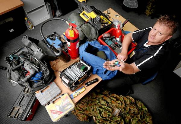 Detective Acting Sgt Andrew Leonard with the cache of stolen property uncovered in a Wodonga garage. Pictures: JOHN RUSSELL