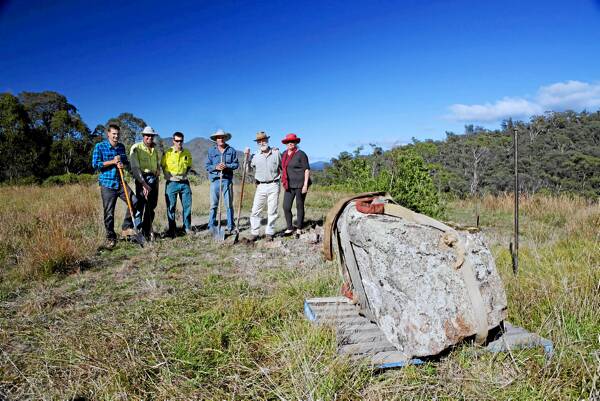 Tom Groggin station hand Haydn Collins, Kosciuszko National Park field officers Michael Kuhn and Dan Marsden, Wayne Turner and Man From Snowy River Tourist Association’s Richard and Sandra Hubbard with the stone for the plaque. Picture: NICOLE VLUG