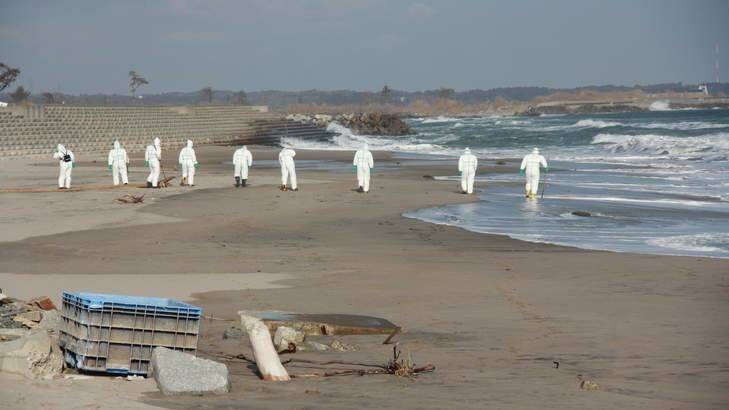 Whatever it takes … police search for missing people on the Fukushima coast. Photo: courtesy of Pan Macmillan