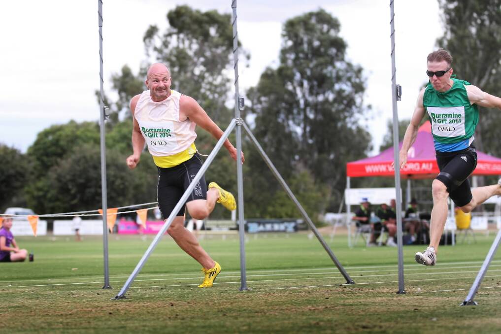 Mark Hignett hits the line to win the $5000 first prize at the Burramine Gift ahead of past winner, and former Albury runner, Derek Collinge.
