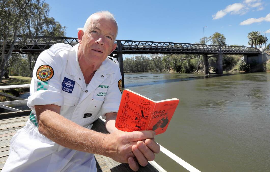 Peter Wright with his log book of drownings. Picture: PETER MERKESTEYN