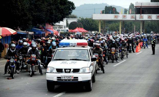 The huge amount of people travelling home by motorcycle has prompted police escorts. Photo: ChinaFotoPress