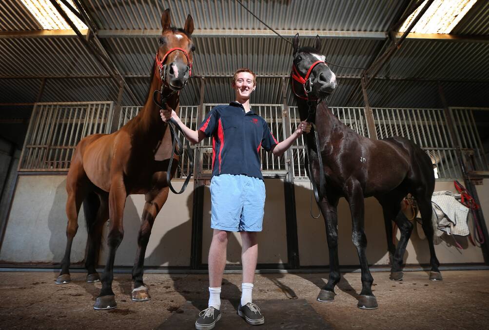 Luke Aldridge, 16, with Towong races hopefuls Set to Run and Rocky Do at the Wodonga stables today. Picture: JOHN RUSSELL