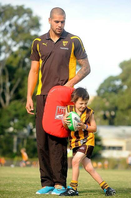Standing tall: Lance Franklin with a young fan at a clinic yesterday.
