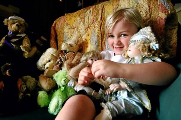 Emily Rowbottom, 4, of Wodonga, gets to cuddle some of the dolls and teddy bears that will be on display this weekend. Picture: NIC GIBSON