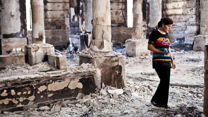A Coptic woman inspects the damage to the Amir Tadros Church in Minya after it was set alight. Photo: Virginie Nguyen Hoang