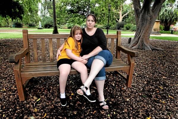 Talon Peatey, 9, with her mother Kristy Parker. Talon walks on the tips of her toes because she needs surgery to lengthen the Achilles tendon in her left leg. Picture: DAVID THORPE