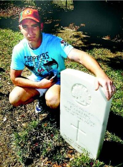 Todd Martin and his grandfather’s gravestone at the cemetery.