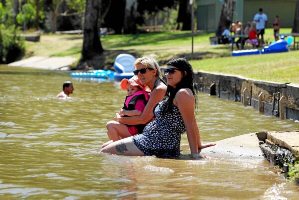 Layla Molina, 3, of Melbourne, cools off in the river with grandmother Sue Leonard and mum Bianca Molina at Rowers Park, where Corowa’s New Year’s celebrations will be held. Picture: MATTHEW SMITHWICK