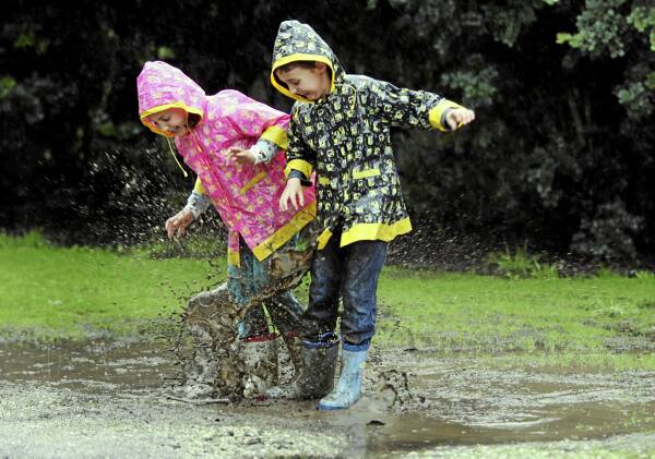Twins Mia and Nathan Johannis, 6, make the most of the puddles at Thurgoona yesterday after widespread rainfall. Picture: PETER MERKESTEYN