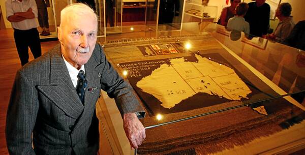 Jim Simpson and the rug he knitted while held captive in a prisoner of war camp. The rug is now in the newly extended Man From Snowy River Museum at Corryong. Picture: MATTHEW SMITHWICK