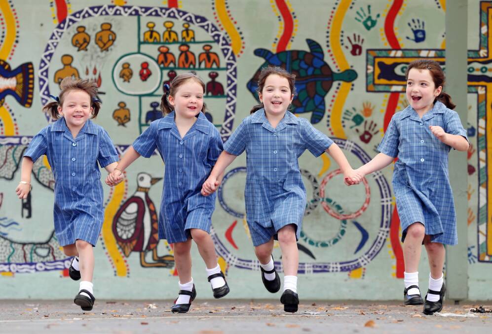 Evie and Jessie Smallacombe and new mates Jasmine and Mia Wilson couldn’t wait until tomorrow to give their school uniforms a run. Picture: JOHN RUSSELL