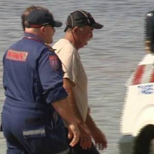 Bob Bogaard is taken to a waiting ambulance after his plane crashed. PICTURE: Prime7 News Albury